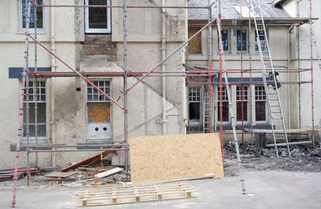Scaffolding surrounding house development for safe access to construction work