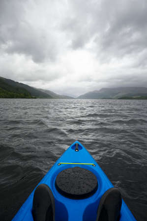 Blue kayak on open water at Loch Lomondの写真素材