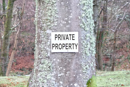 Private property sign fixed to tree in woodlandsの写真素材