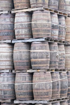 Whisky casks stacked at distillery for storageの写真素材