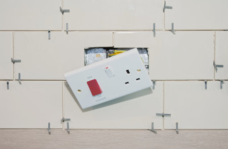 New tile installation in kitchen with electrical sockets removed