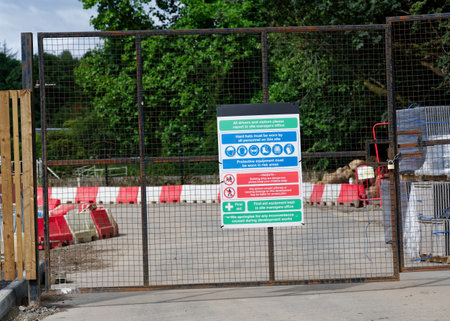 Construction site health and safety message rules sign board signage on fence boundary