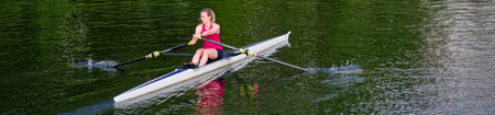 Women training on canoe to practise rowing during early morning on riverのeditorial素材