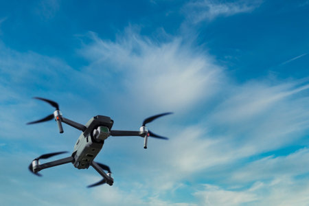 Drone flying against dark blue sky