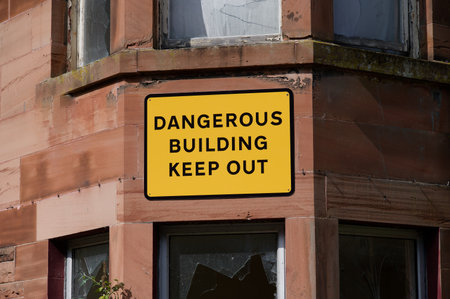 Dangerous building keep out sign on building ready to be demolishedの写真素材
