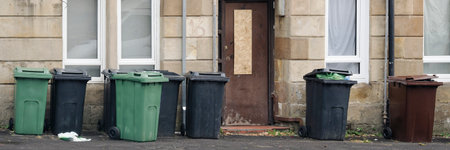 Wheelie bins in row for refuge collection outdoorsの写真素材