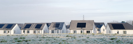 Solar panels installed on home roofs at new housing developmentの写真素材