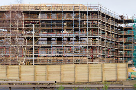 Scaffolding surrounding residential development for safe access to construction work