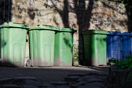 Wheelie bins in row for refuge collection outdoors