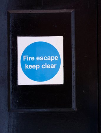Fire exit keep clear sign on construction building site doorの写真素材