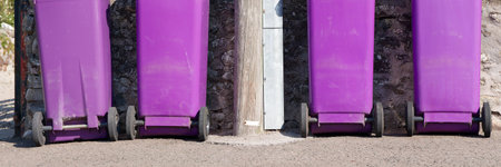 Purple wheelie bins refuge collection outside house in a rowの写真素材
