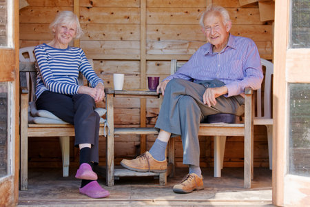 Senior elderly couple in summerhouse during summerの写真素材