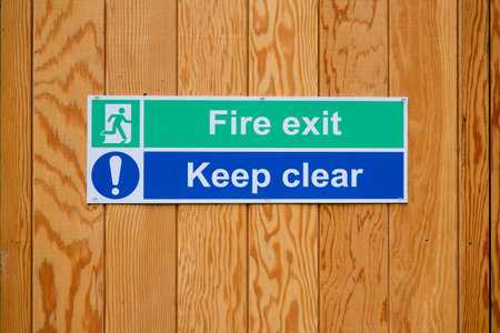 Fire exit keep clear sign on construction building site doorの写真素材
