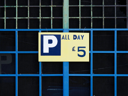 Car parking cost sign on fence in cityの写真素材
