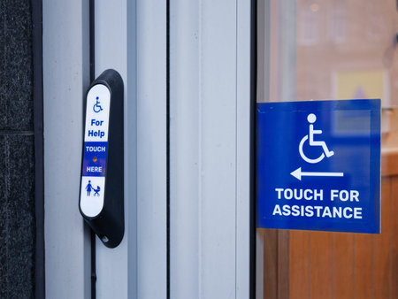 Disabled accessible push button buzzer for assistance sign at building entrance