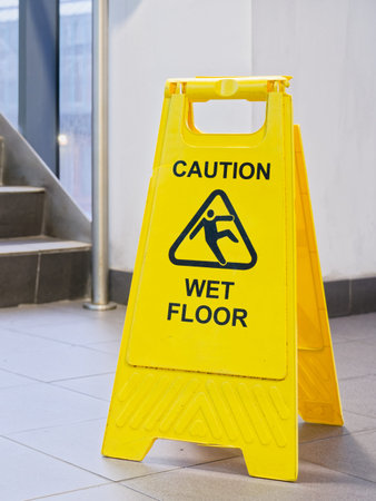 Caution wet floor cone safety notice at public stair