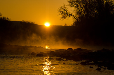 Sunrise on a Misty Riverの写真素材