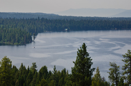 People Enjoying Summer Lake in the Mountains