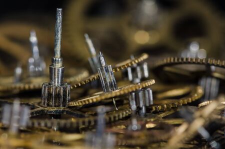 Watch Parts: Collection of Vintage Metallic Watch Gears on a Black Surfaceの写真素材