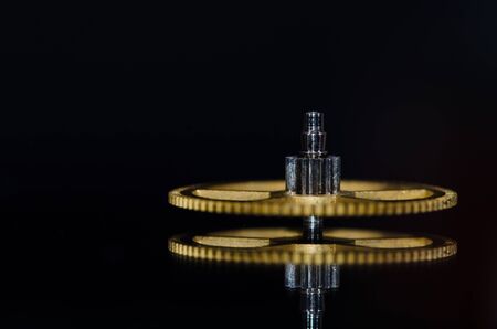 Watch Parts: Vintage Metallic Watch Gear on Black Background