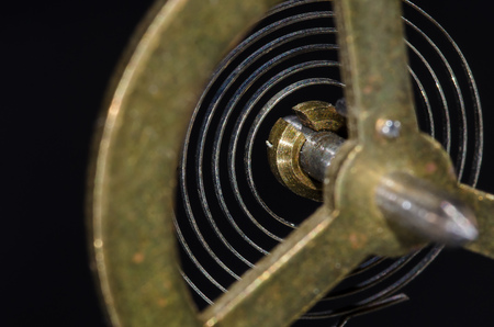 Abstract: Looking Through a Vintage Metallic Balance Wheel to Its Hairspringの写真素材