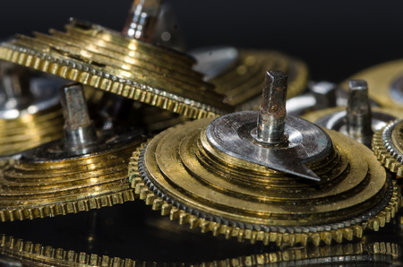 Watch Repair: Vintage Pocket Watch Fusee Cones Resting on a Black Surface