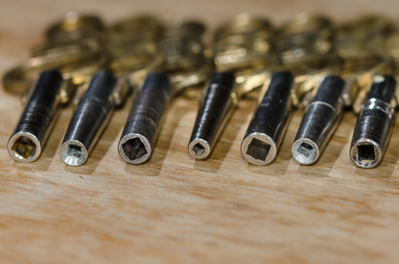 Row of Antique Pocket Watch Keys Laying on the Watchmakers Benchの写真素材