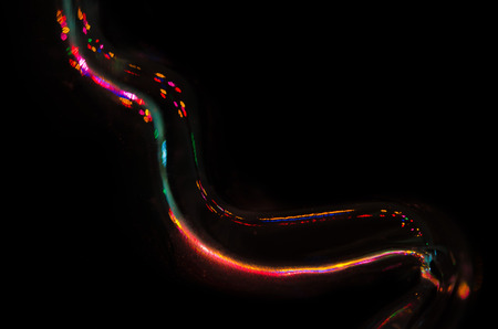 Abstract: Flow of Colored Light Reflecting in the Blacknessの写真素材