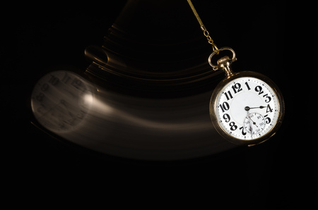 Swinging Pocket Watch Beckoning You to Look More Closelyの写真素材