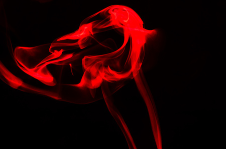 Nature Abstract: The Delicate Beauty and Elegance of a Wisp of Red Smokeの写真素材