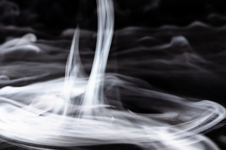 Nature Abstract: The Delicate Beauty and Elegance of a Wisp of White Smokeの写真素材