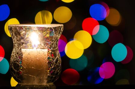 White Christmas Candle Enveloped in Christmas Lightsの写真素材