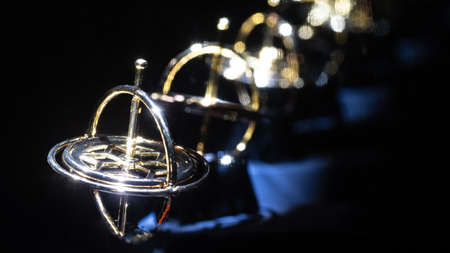 Golden Gyroscope Reflecting Endlessly in the Darknessの写真素材
