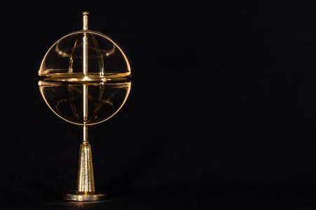 Golden Gyroscope Spinning Steadily on its Baseの写真素材
