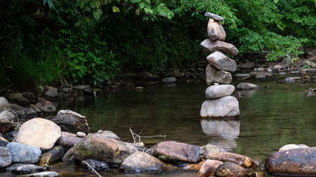 Rough Stone Cairns Standing Proudly in the Shallow Creek Water