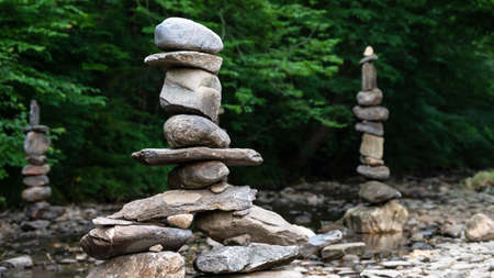 Rough Stone Cairns Standing Proudly in the Shallow Creek Water