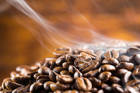 pile of hot coffee beans with smoke pile of hot coffee beans with smoke