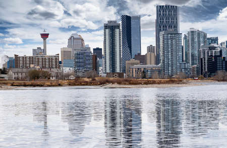 Calgary Alberta Canada, April 01 2022: Scenic view of the downtown East Village district and skyline reflecting onto the Bow river.のeditorial素材