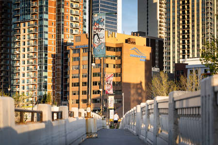 Calgary Alberta Canada, May 16 2022: A person jogging across the 10th street bridge pedestrian path into the downtown centre.のeditorial素材