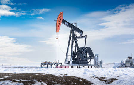Rocky View County Alberta Canada, May 12 2022: Oil and gas industry pump jack in motion working on a...