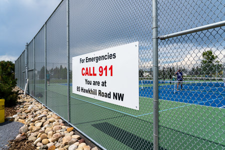 Calgary Alberta Canada, July 09 2022:  Emergency location sign at a public pickle ball park in the North West community of Hawkwood.のeditorial素材