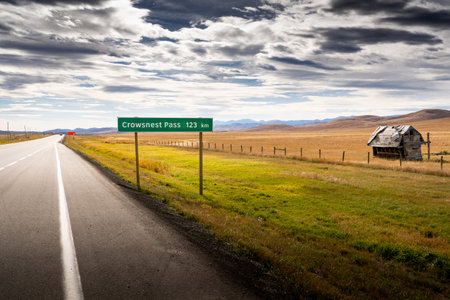 Longview Alberta Canada, October 16 2022: Crowsnest Pass road sign along the Cowboy Trail and highway 22 near the Eastern Slopes of the Canadian Rocky Mountains under a dramatic skのeditorial素材