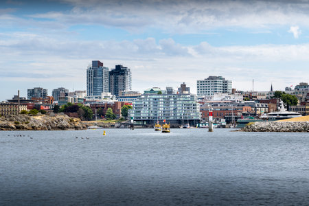 Victoria British Columbia Canada, July 12 2023: A pair of water taxi boats cross through the narrows...