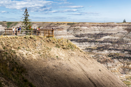Horseshoe Canyon Alberta Canada, August 7 2023: Tourists standing at a viewpoint overlooking a popular badlands valley with hoodoos and historic lands.のeditorial素材