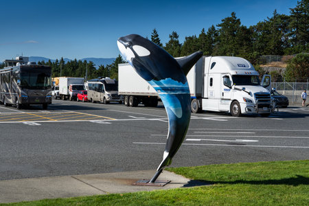 Duke Point British Columbia Canada, July 23 2023: Artistic Orca public art display at a ferry terminal overlooking travellers and transport trucks during summer vacation.のeditorial素材