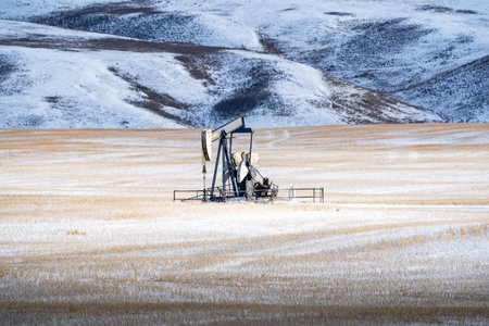Oil pump on the background of a snowy field. Oil industry.の写真素材