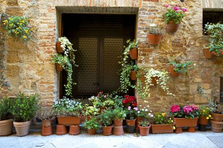 Walls and flowers in villages in Tuscany region of Italy.の写真素材