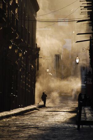 Person sweeping a cobblestone street, Mexico.の写真素材