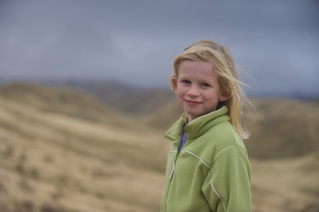 Young blond girl with blue eyes looking into the cameraの写真素材