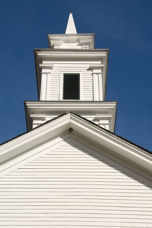 White clapboard church in New England, with a steeple.の写真素材